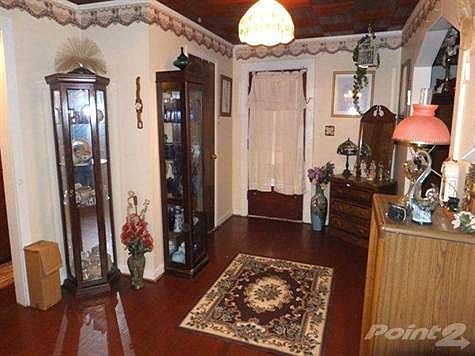 Large hall as you walk into the home. Hardwood floors have recently been redone. This picture is taken from the dining room back toward the front door.