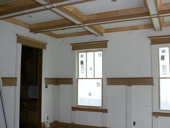 Large dining room with coffered ceiling, lots of natural light, direct access to kitchen through butler pantry