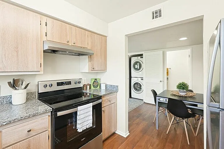 Experience modern living with this stylish kitchen and a cozy dining nook.