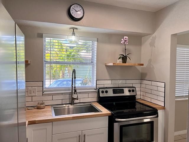 kitchen with new appliances and butcher block countertops
