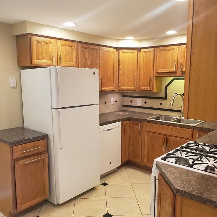 Kitchen area with refrigerator, dishwasher.