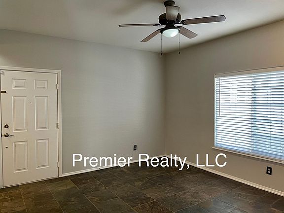 Nice and bright living room with ceiling fan