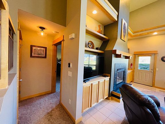 The door to the main floor primary room is just off the living room.