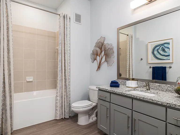 Rhythm Bathroom with Large Shower and Quartz Countertop Vanity