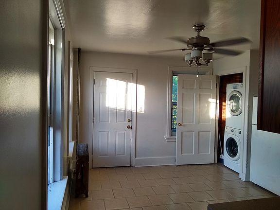 Kitchen, exit to rear balcony, and full-size washer & drier