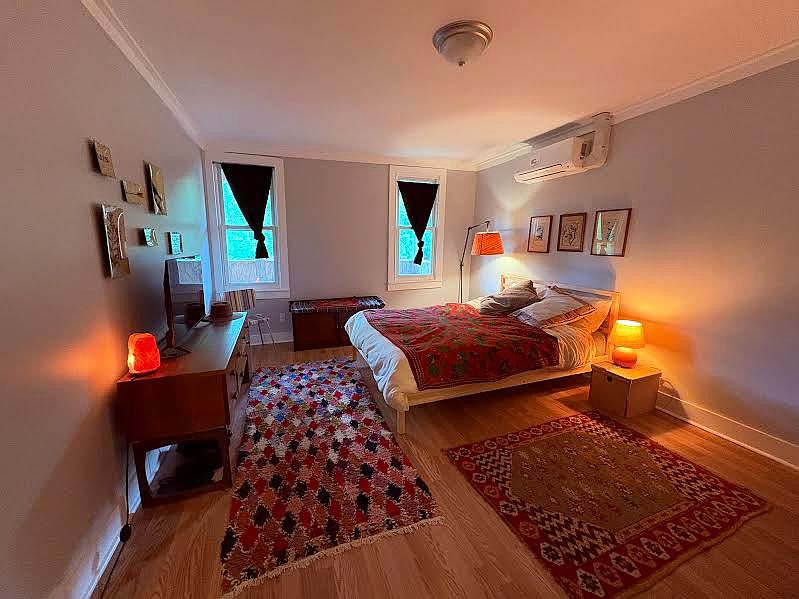 large bedroom, queen bed, with closet and two dressers
