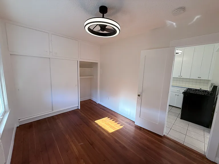 Bedroom w large windows and built in closets and extra storage. Fan light is adjustable on light warmth and fan speed.