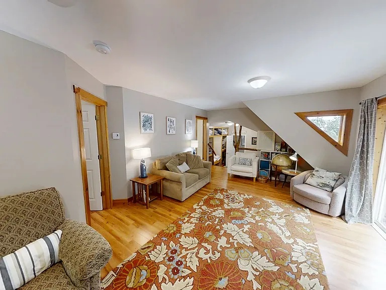 Third level living, deck area and view of bedrooms 4 & 5