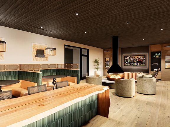 7th floor nature-inspired clubroom with catering kitchen, double-sided fireplace, and comfortable lounge seating.