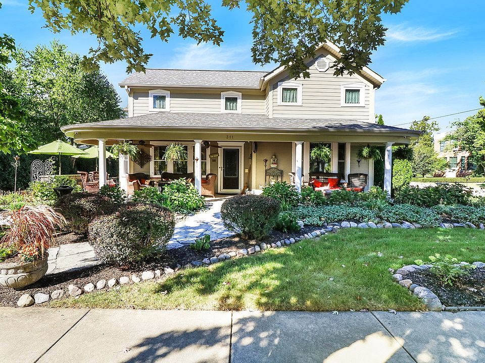 Beautiful, corner lot with lush landscaping, covered porch and private patios throughout the yard