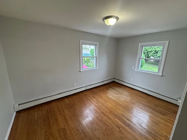 Bedroom 2: features natural lighting, hardwood floors and closet