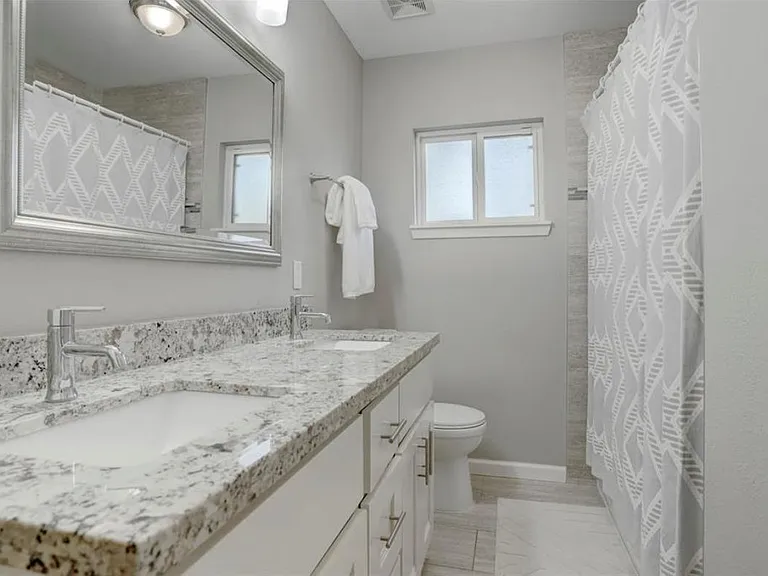 Hall bath with bathtub and double sinks
