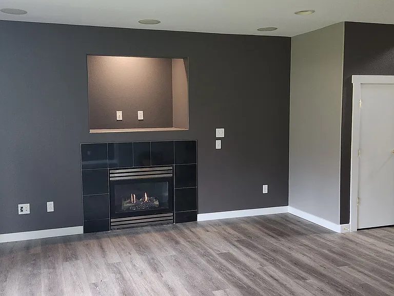 Living room with gas fireplace and black granite surround