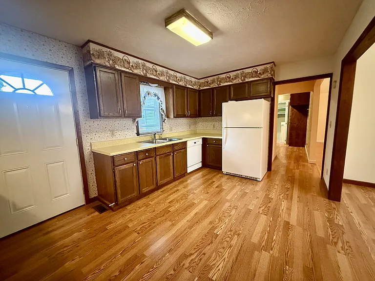 Kitchen with dishwasher and refrigerator.