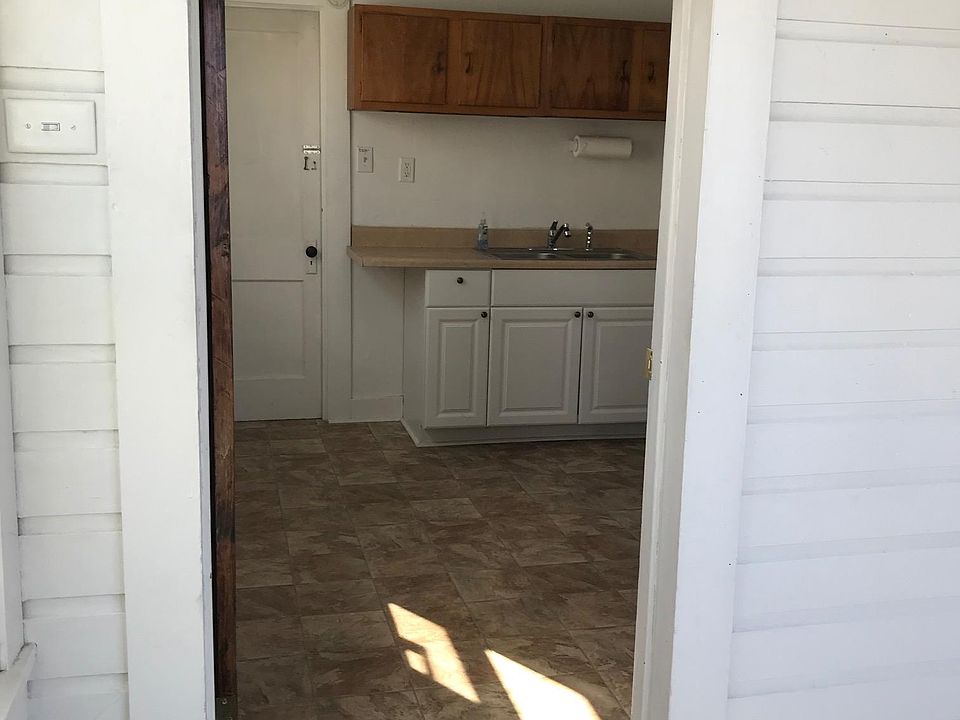 Kitchen with small laundry beyond