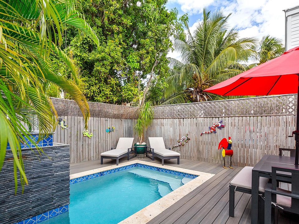 pool with dining set and lounges which stay with. house