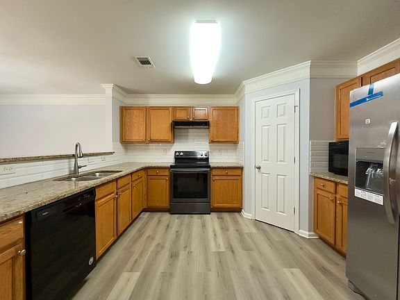 Kitchen provides ample cabinet space and a brand new refrigerator