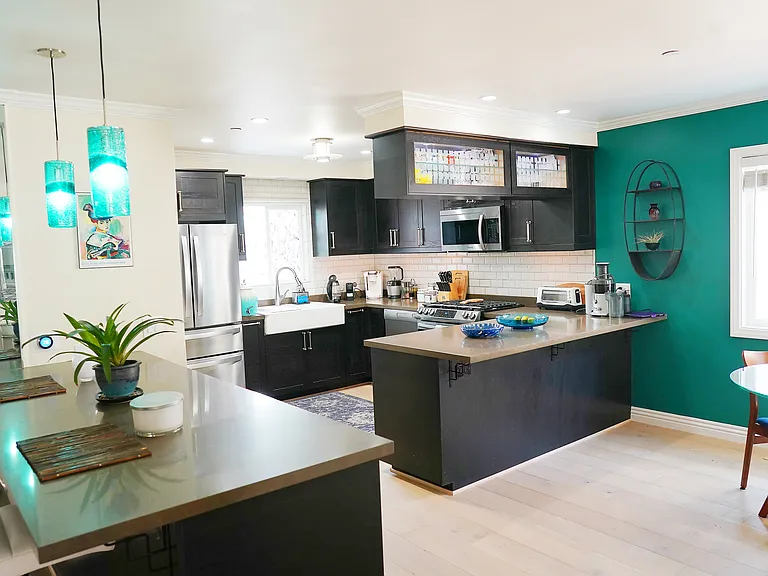 Open concept kitchen equipped with all new stainless steel appliances, breakfast nook, Living room