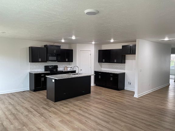 Open concept kitchen, dining area, and living room