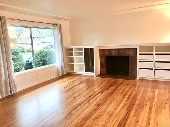 living room with fireplace for cozy winter evenings and huge windows making the space light and bright