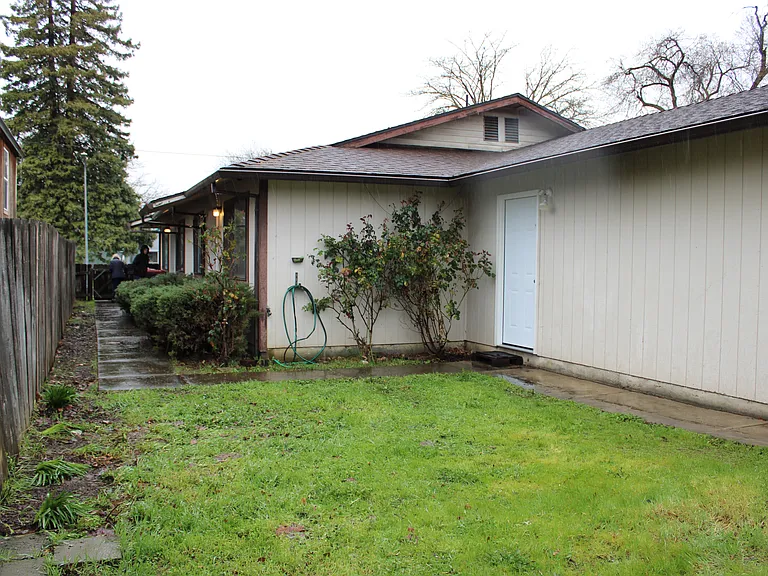 Fenced yard, shared space with another unit.
