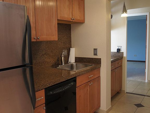 Kitchen fully updated -- tile floor, cabinets, granite tile countertops, appliances, lighting