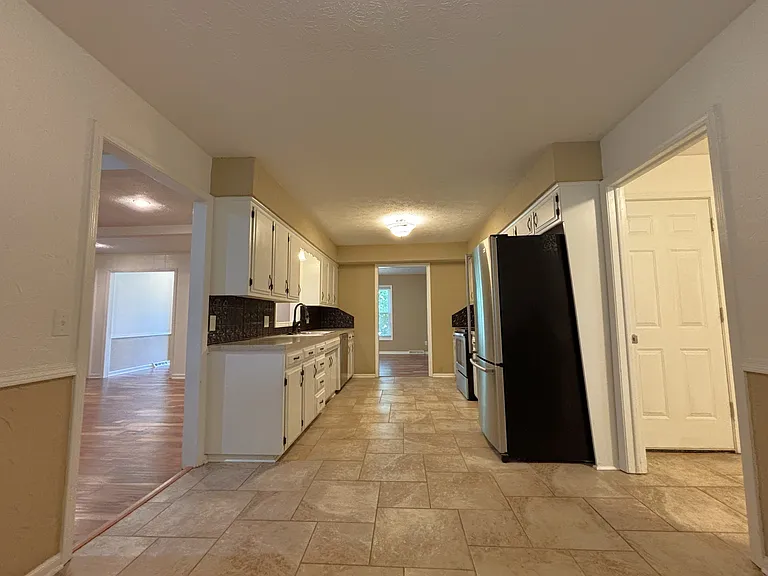 Kitchen view from Breakfast Nook with Living Room to the left and Laundry and Garage to right