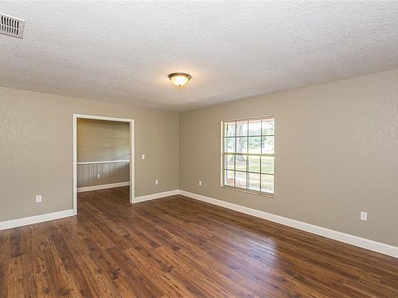 Large room that could be used as formal living room or dining room or playroom right off family room and front door area