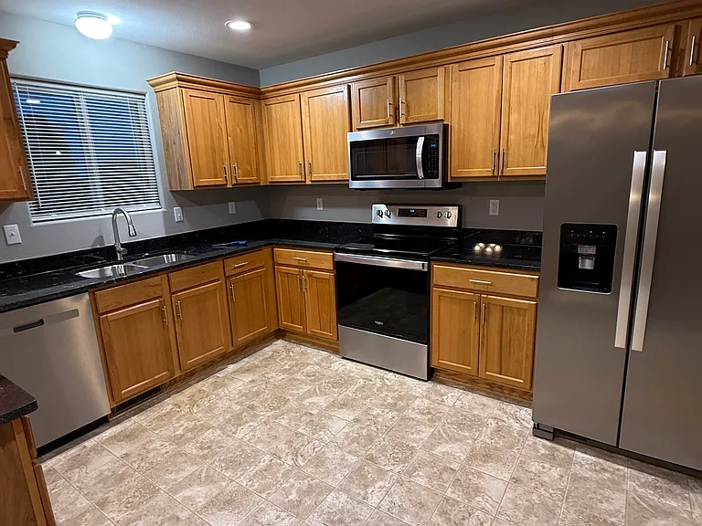 Three year-old 25 foot refrigerator, by burner glass top stove with self clean convection oven. Microwave, dishwasher, and garbage disposal.