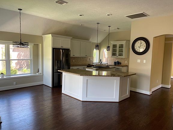 open concept kitchen with gas range top and updated appliances