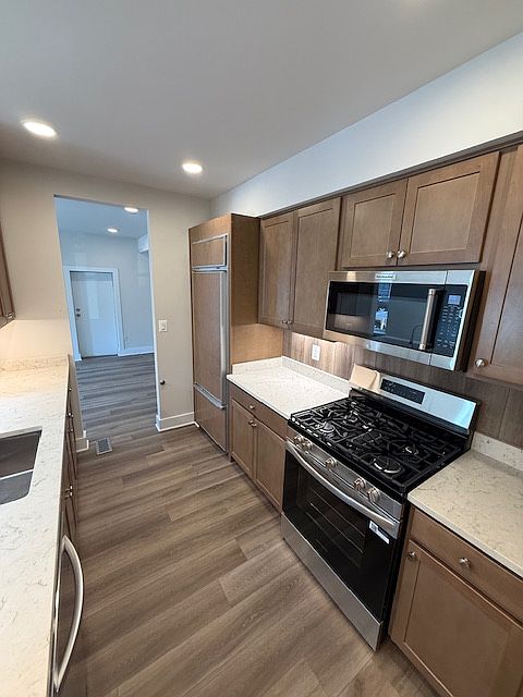 Kitchen/bar area includes all appliances - SubZero refrigerator, built-in microwave and brand new gas stove/oven.