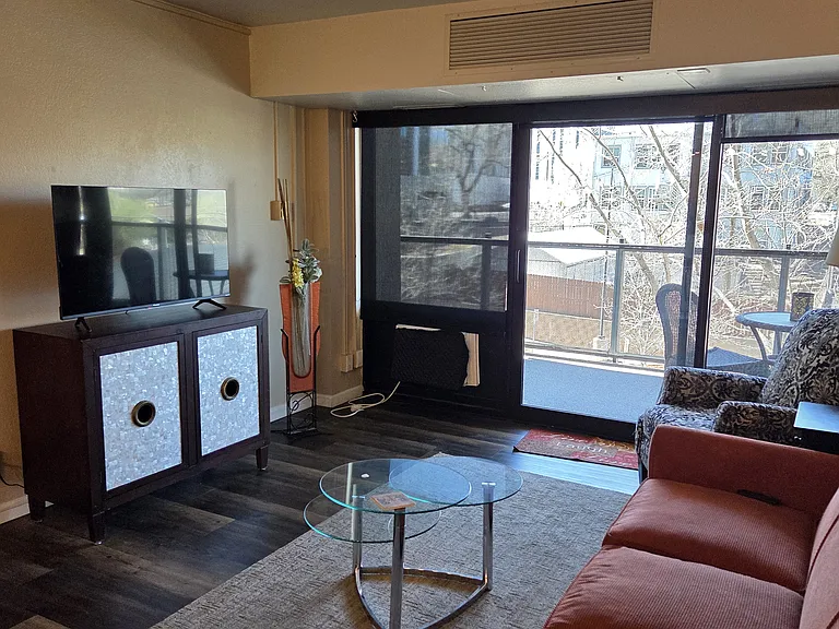 Living room with 45" TV and walk out to covered balcony