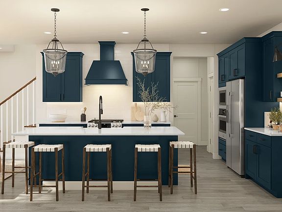 Kitchen with blue cabinetry pendant lights