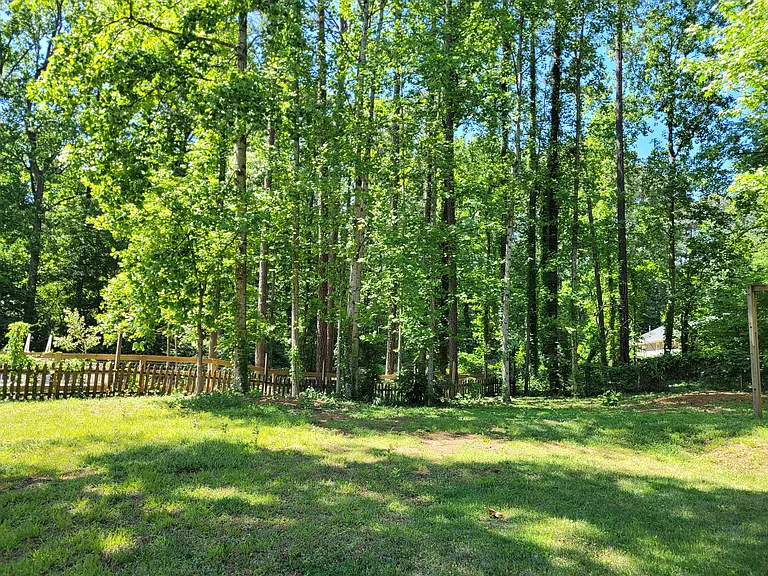 Backside of yard. Very usable. Perfect for pets or gardening.