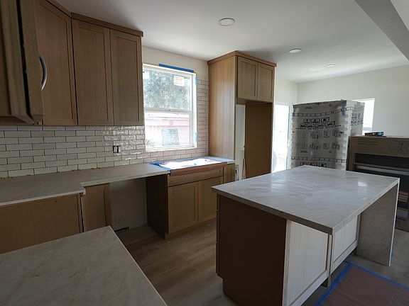 Here is a view of the kitchen from the hallway that leads to the 4 bedrooms