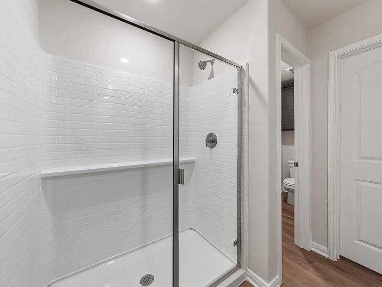 The master bathroom has a glass, walk-in shower.