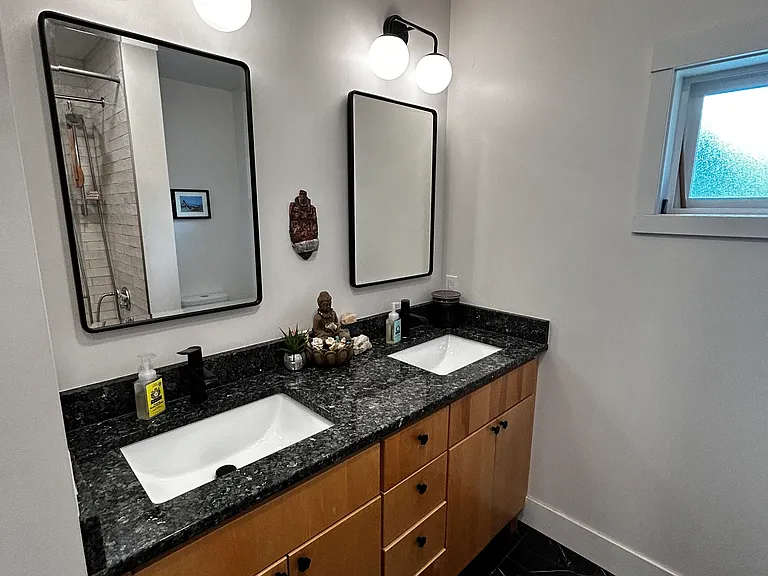 Double vanity with heated tile floor in bathroom