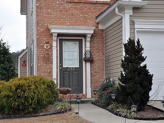 Elegant front entrance w/detailed woodwork invites owners & guests inside