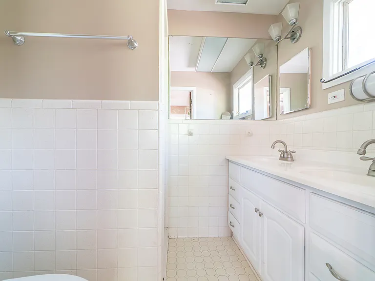 master bathroom has double sink and new fixtures