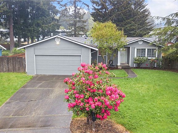 Fresh exterior paint and mature landscaping.