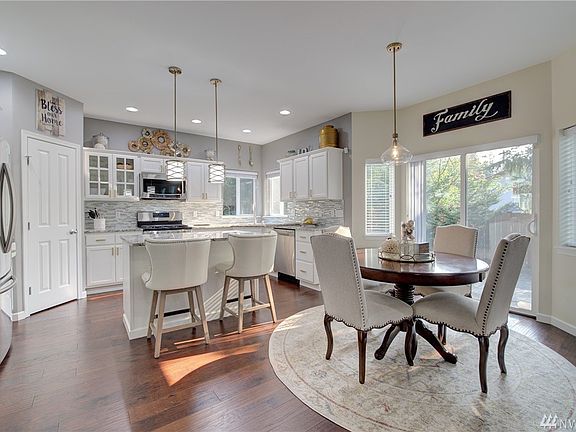 A spacious breakfast nook is a great segue between the kitchen and family room.  Here you'll find access to the backyard patio as well.  