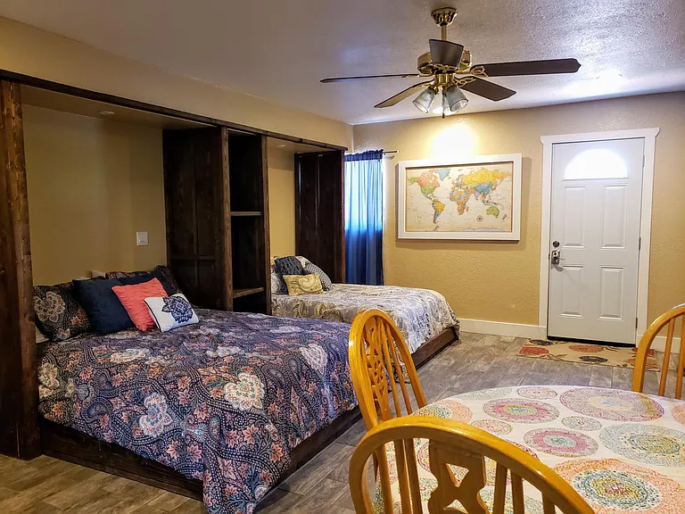Bedroom 1: Mother-in-law Suite 
This is a huge room with two beds, a private entry, a private bathroom, a private patio, a mini kitchenette area, a tv, and a fireplace. We use this room as a guest room, and it's basically a tiny house.