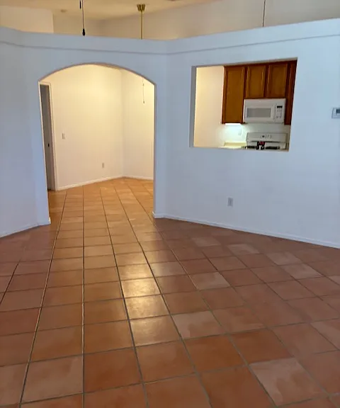 Living room has archway entry into dining area