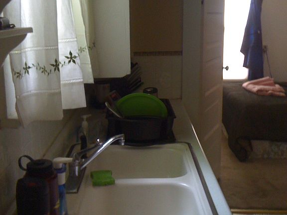Kitchen looking into big bedroom