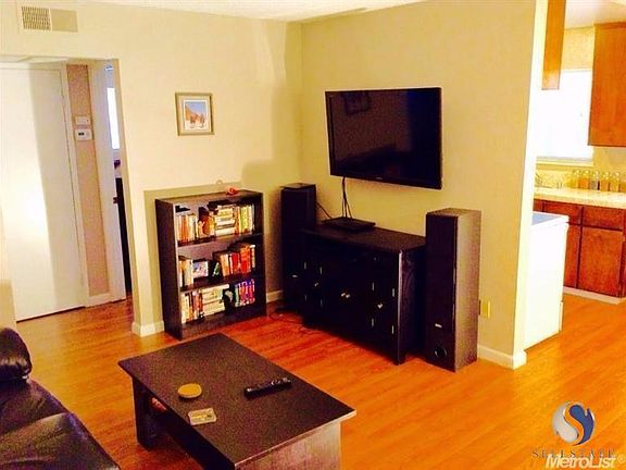 Living area, bedroom and kitchen entry.