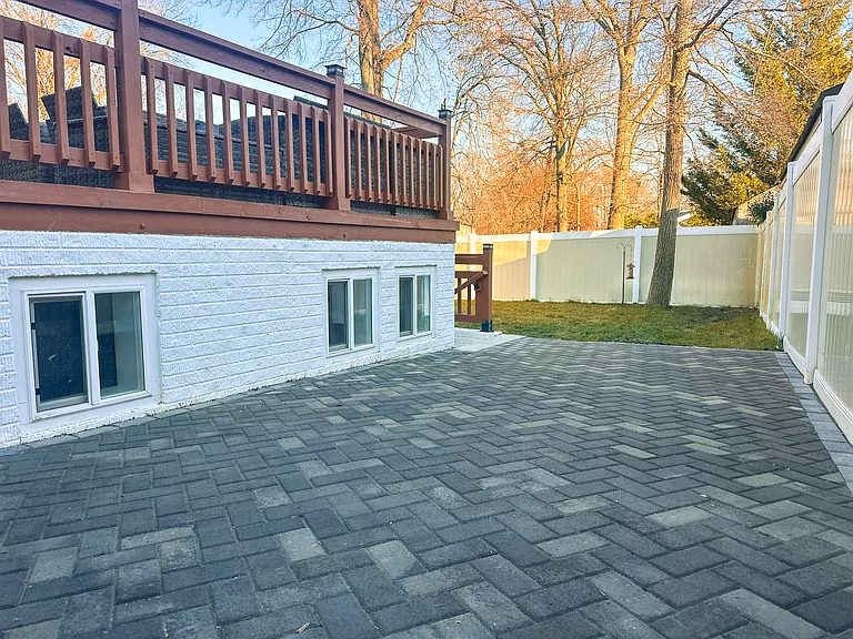 Spacious fenced outdoor area with clean hardscaping and room for pets or entertaining.
