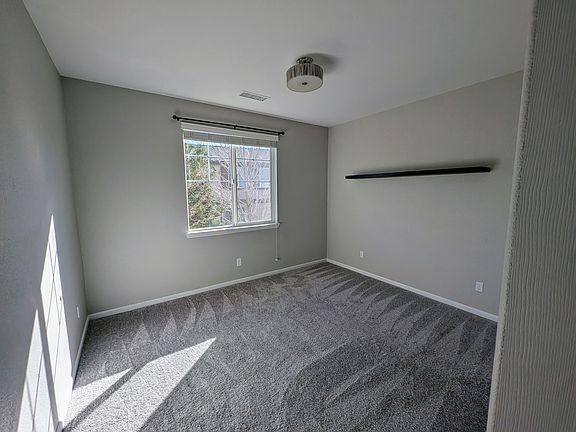 First room that is east facing. One window and closet with carpet and ceiling lamp. Shelf included.