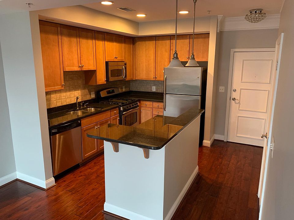 Kitchen boasts lots of upgrades: stainless steel appliances, two gas ovens (one with convection option), icemaker and water dispenser in the fridge. Over counter lighting as well as the island and ample cabinet space with pull-out drawers in the lower cab