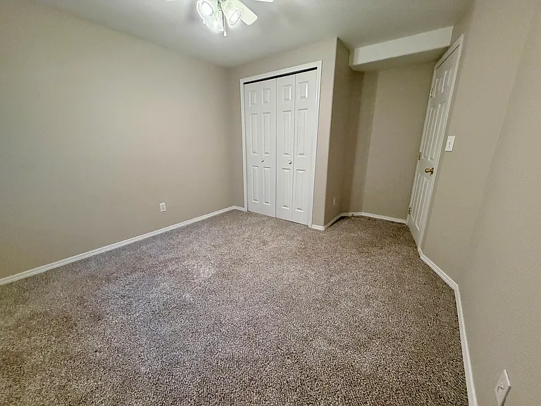Additional view of the third bedroom highlighting the spacious layout, closet storage, and flexibility for use as a guest room, office, or personal retreat.