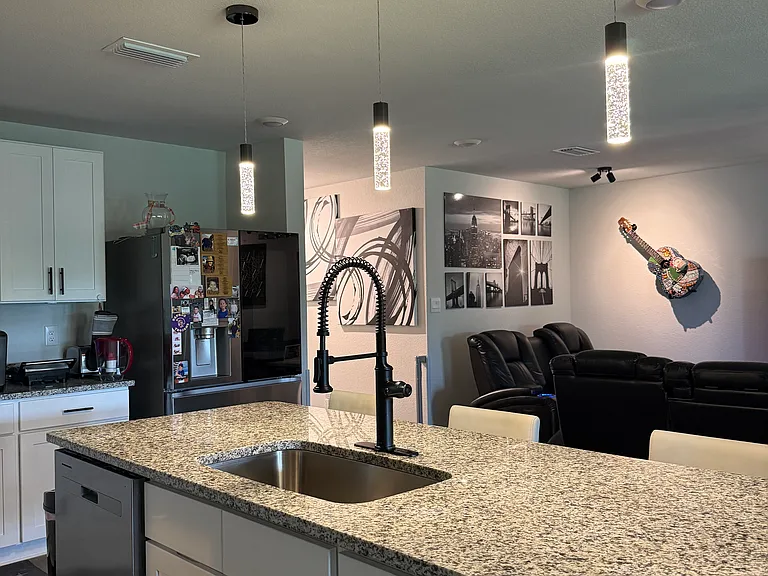 Central island with sink and a luxury kitchen faucet.